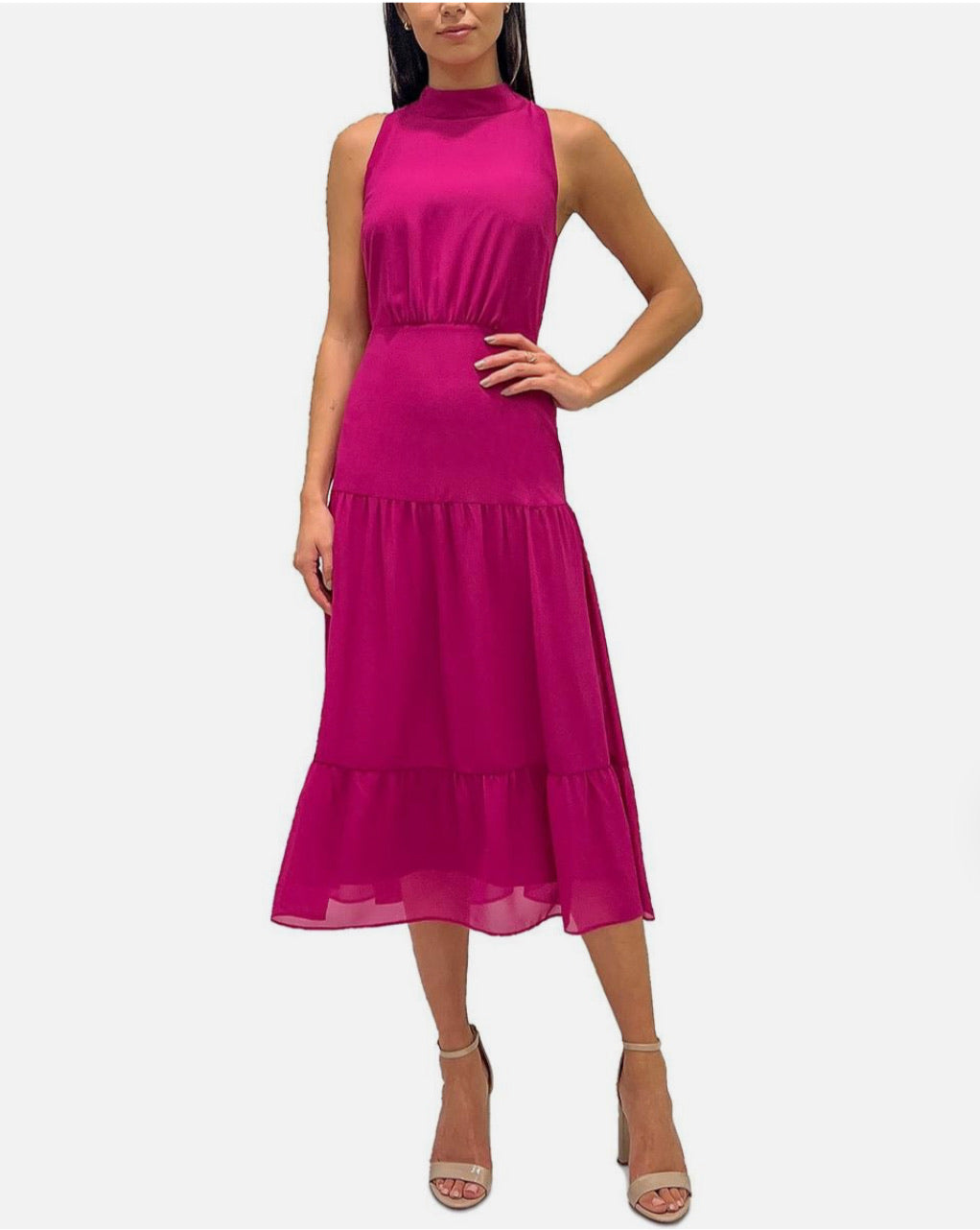 Woman wearing a bright pink dress on a white background