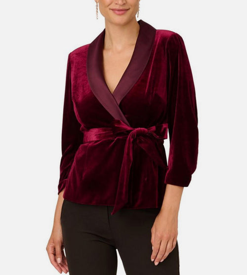 Burgundy velvet wrap top worn by a model on a white background
