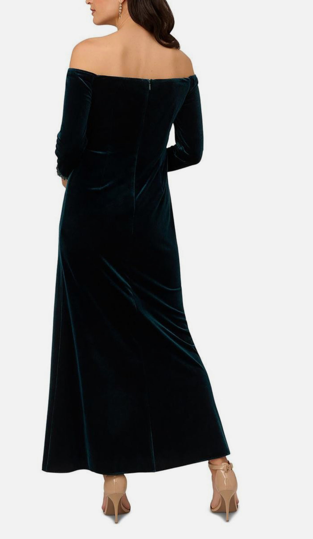 Woman wearing a black off-shoulder velvet dress on a white background