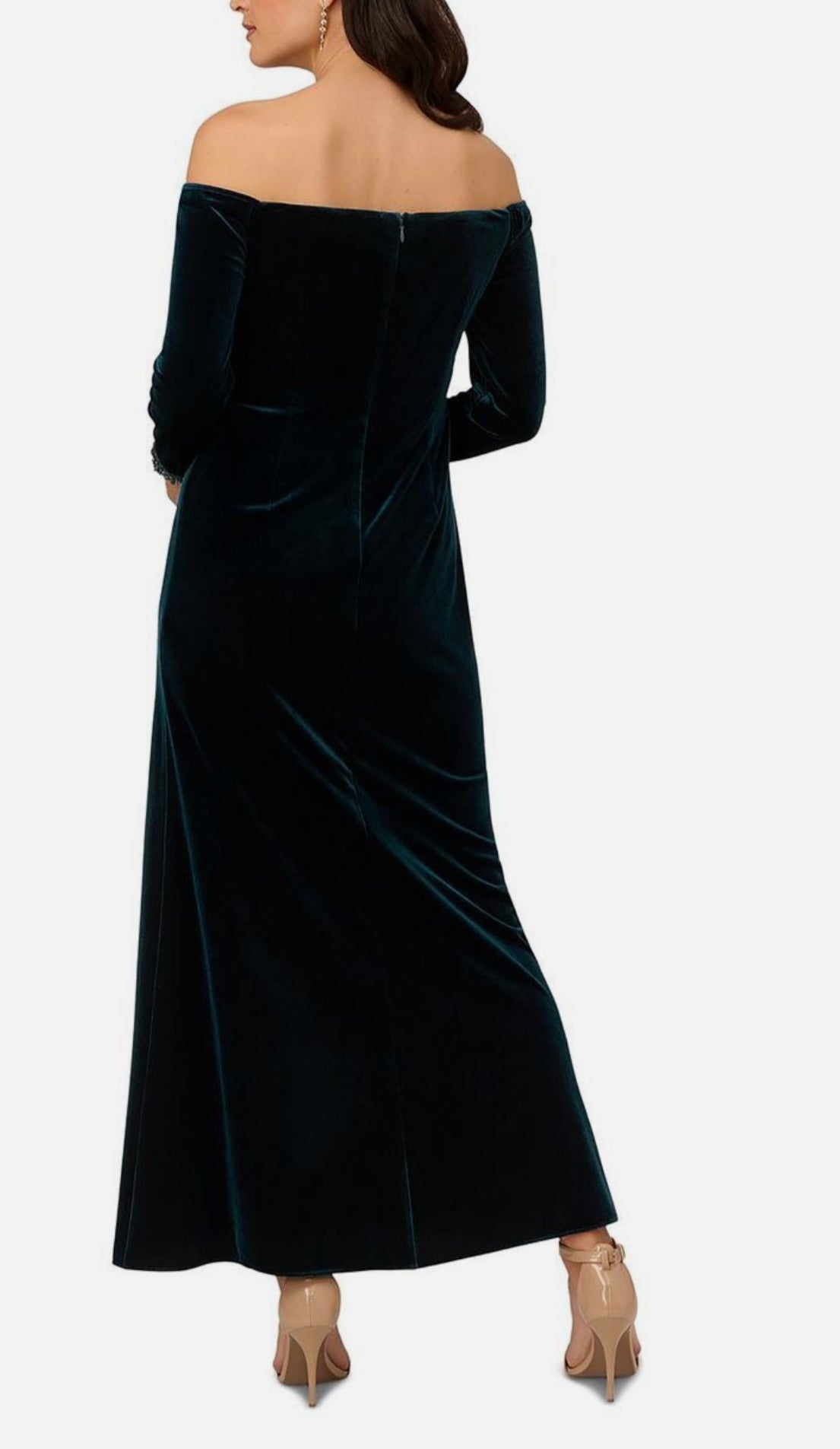 Woman wearing a black off-shoulder velvet dress on a white background