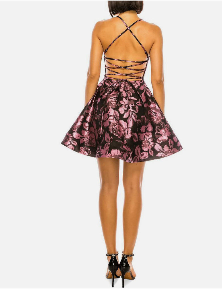 Pink floral dress with strappy back on a white background