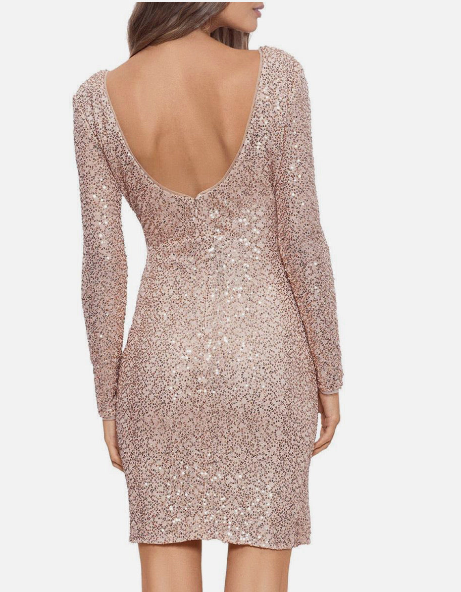 Back view of a sparkly dress with long sleeves on a white background