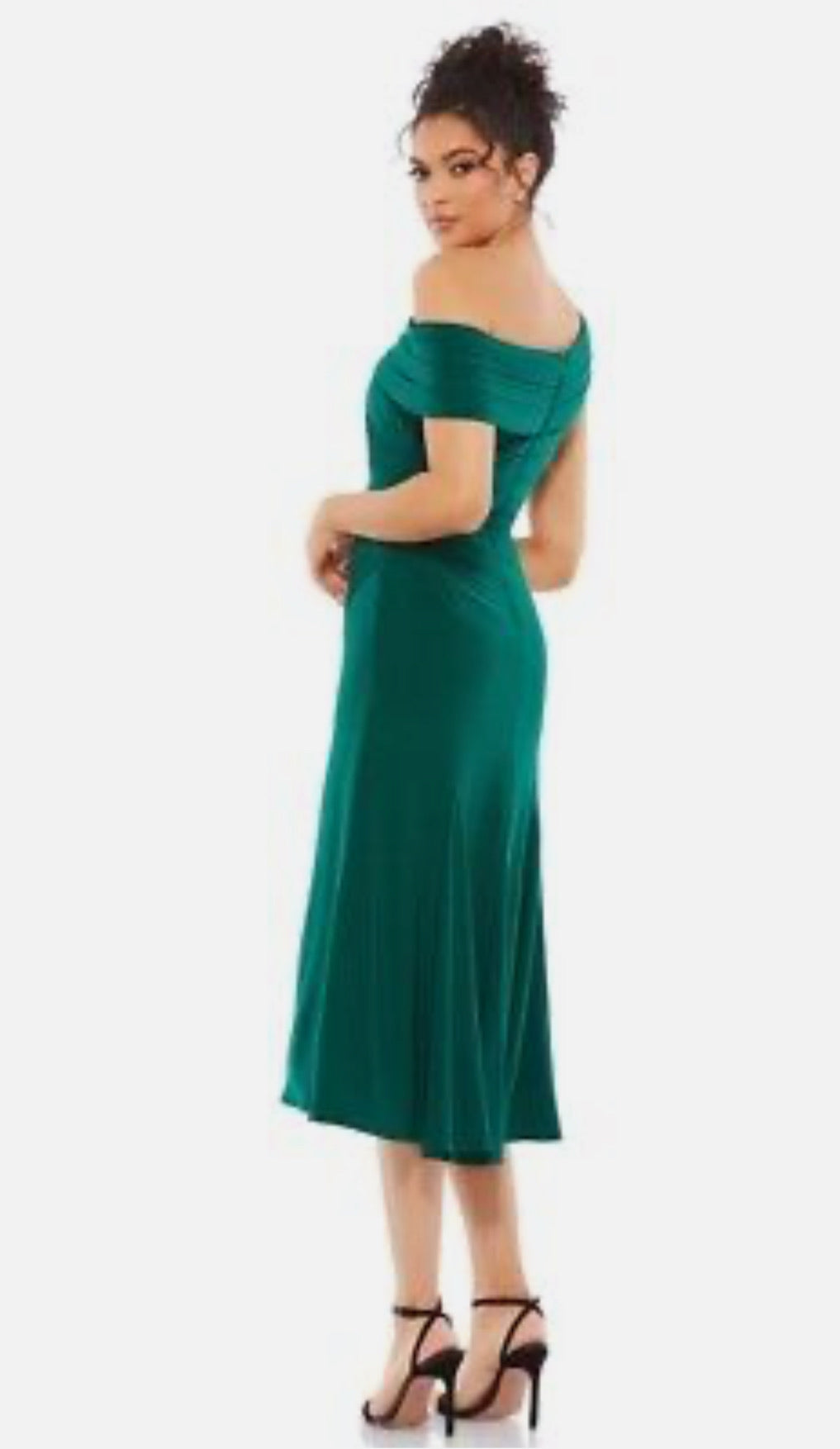 Woman wearing a green off-shoulder dress on a white background