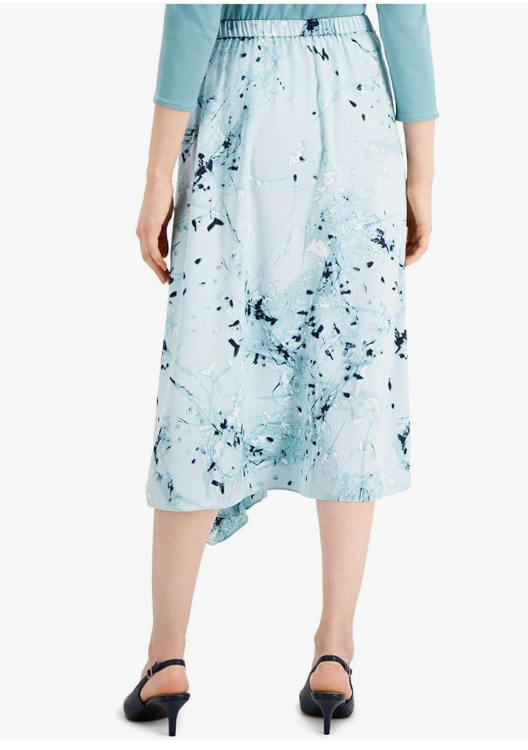 Light blue floral skirt worn by a person on a white background