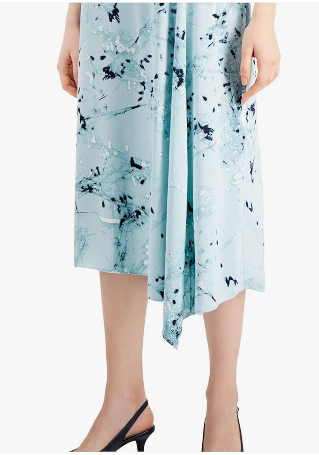 Light blue dress with black abstract pattern worn by a person on a white background