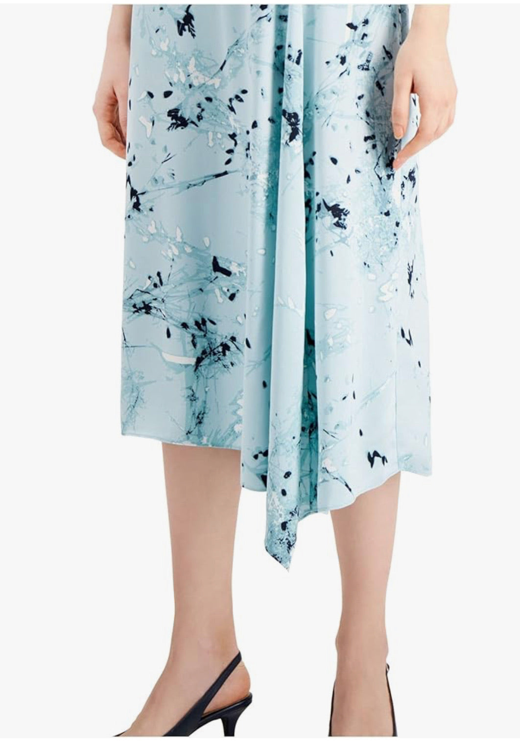 Light blue dress with black abstract pattern worn by a person on a white background