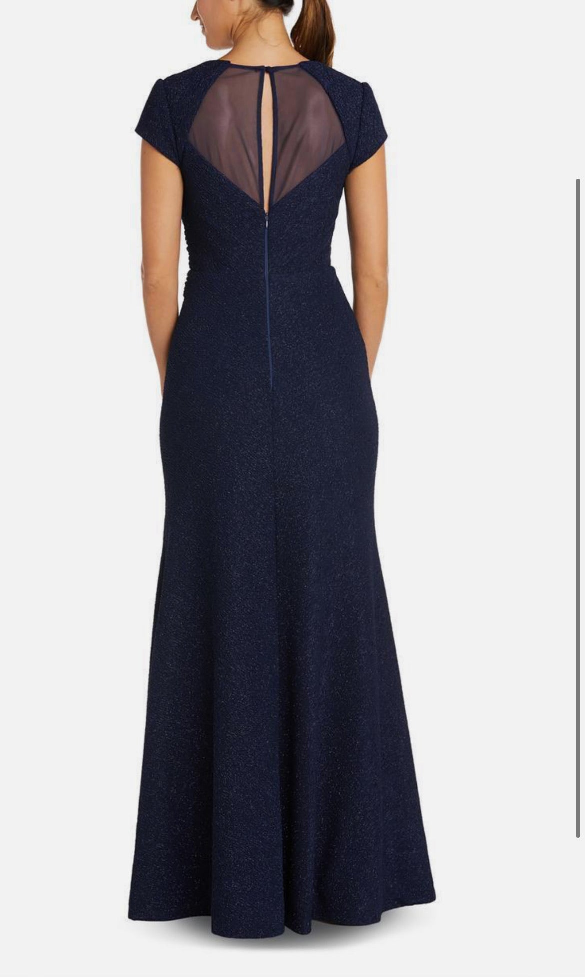 Navy blue evening gown with sheer back on a white background