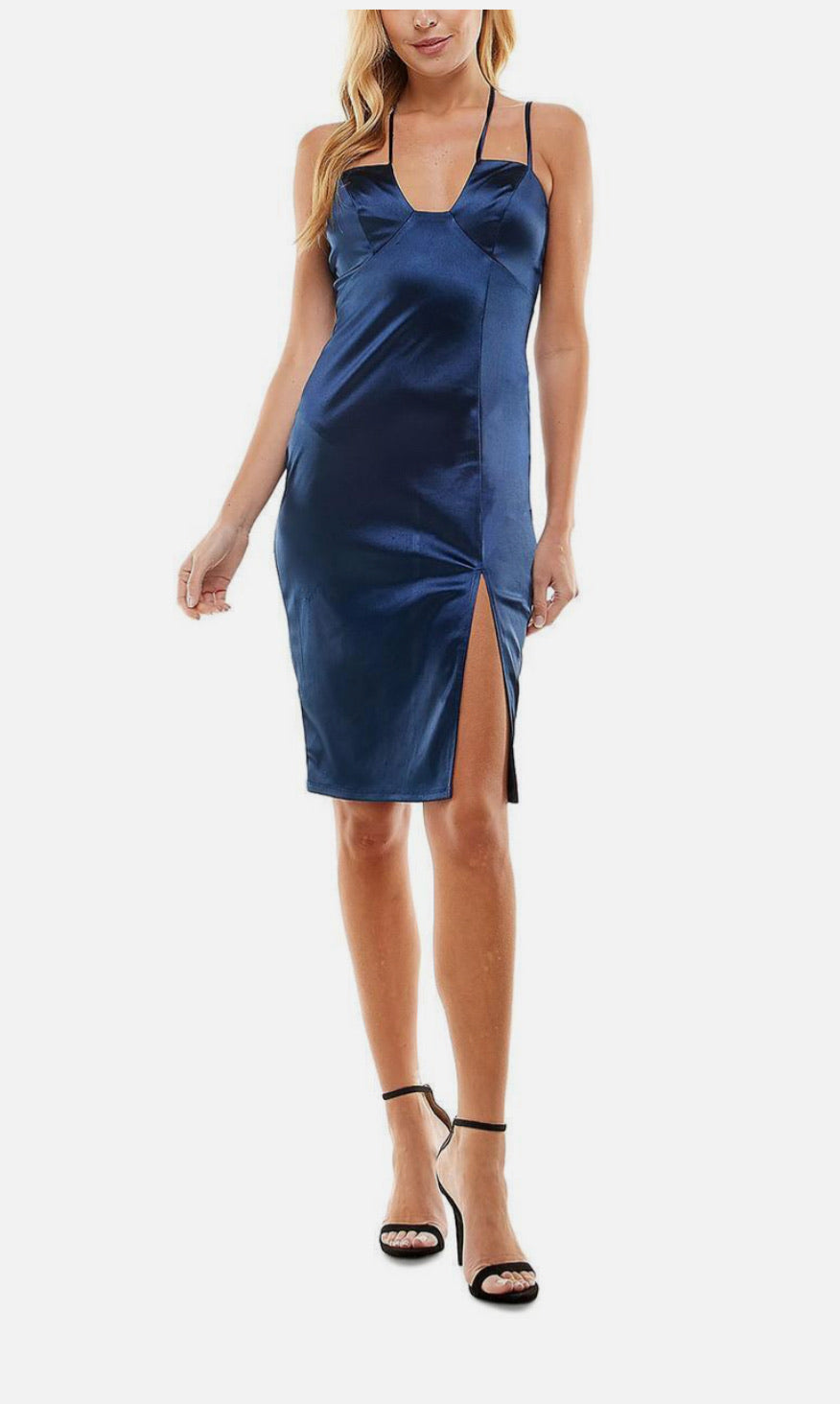 Woman wearing a blue satin slip dress on a white background