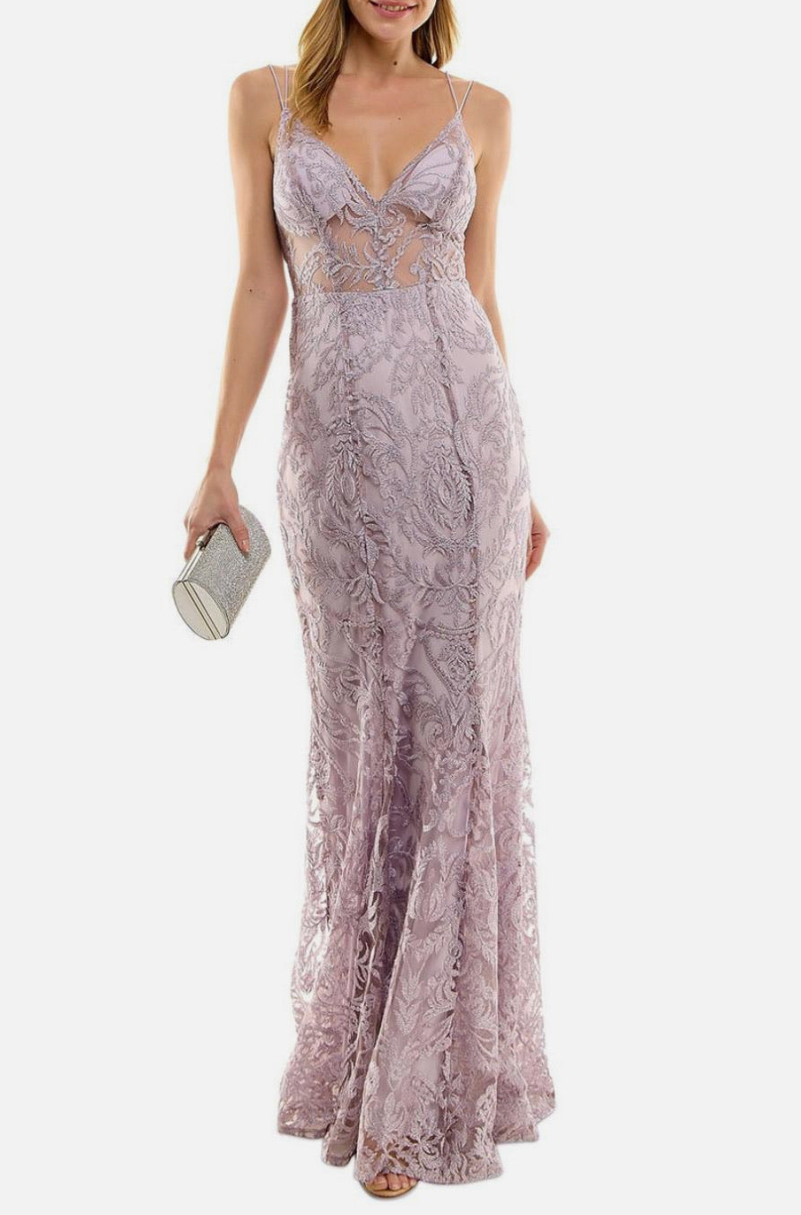 Woman wearing a purple lace evening gown on a white background