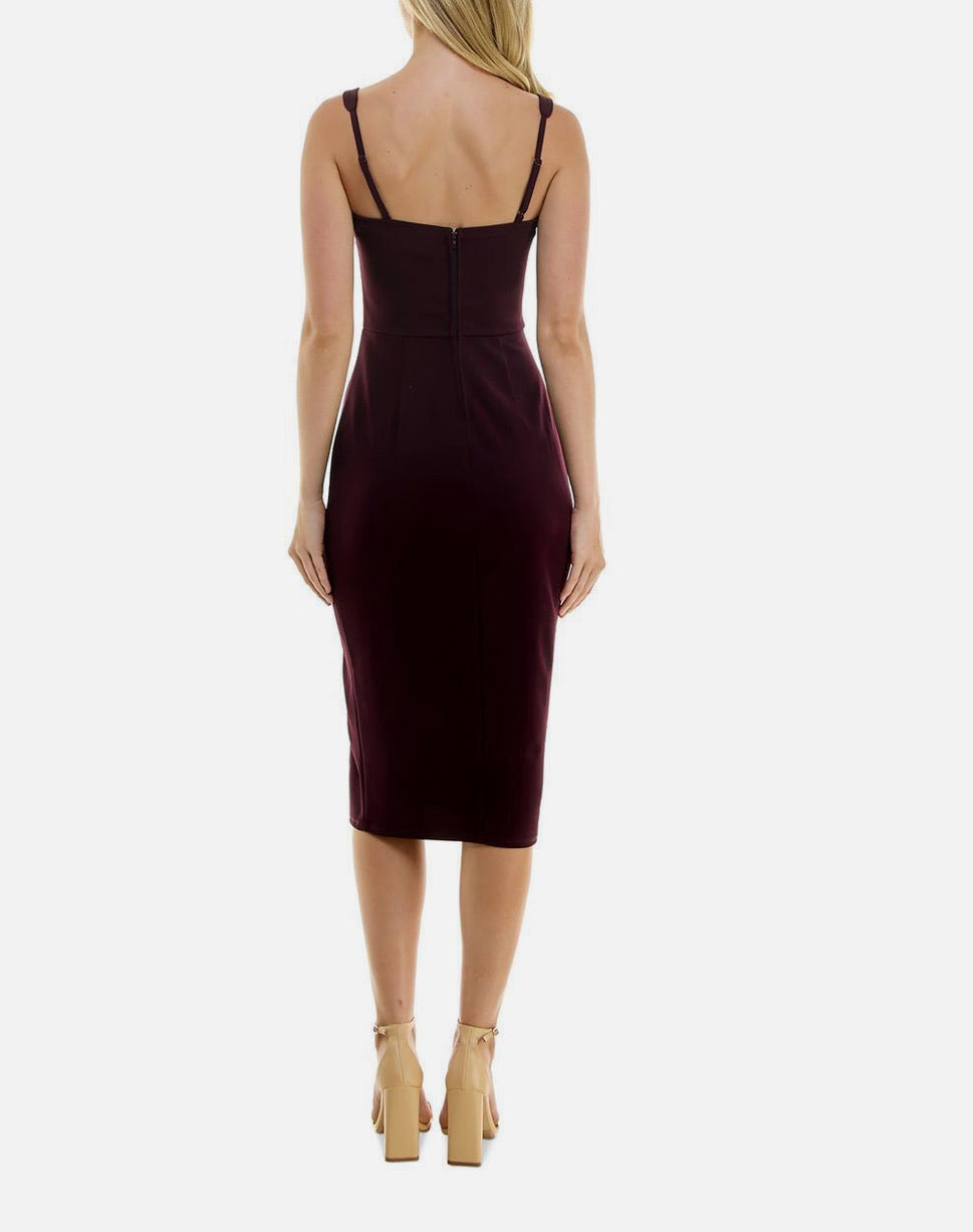 Woman wearing a burgundy dress with thin straps on a white background