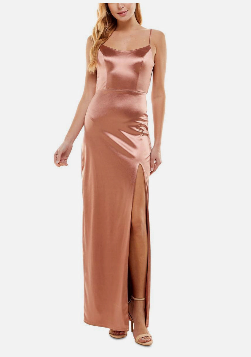 Woman wearing a rose gold satin dress on a white background