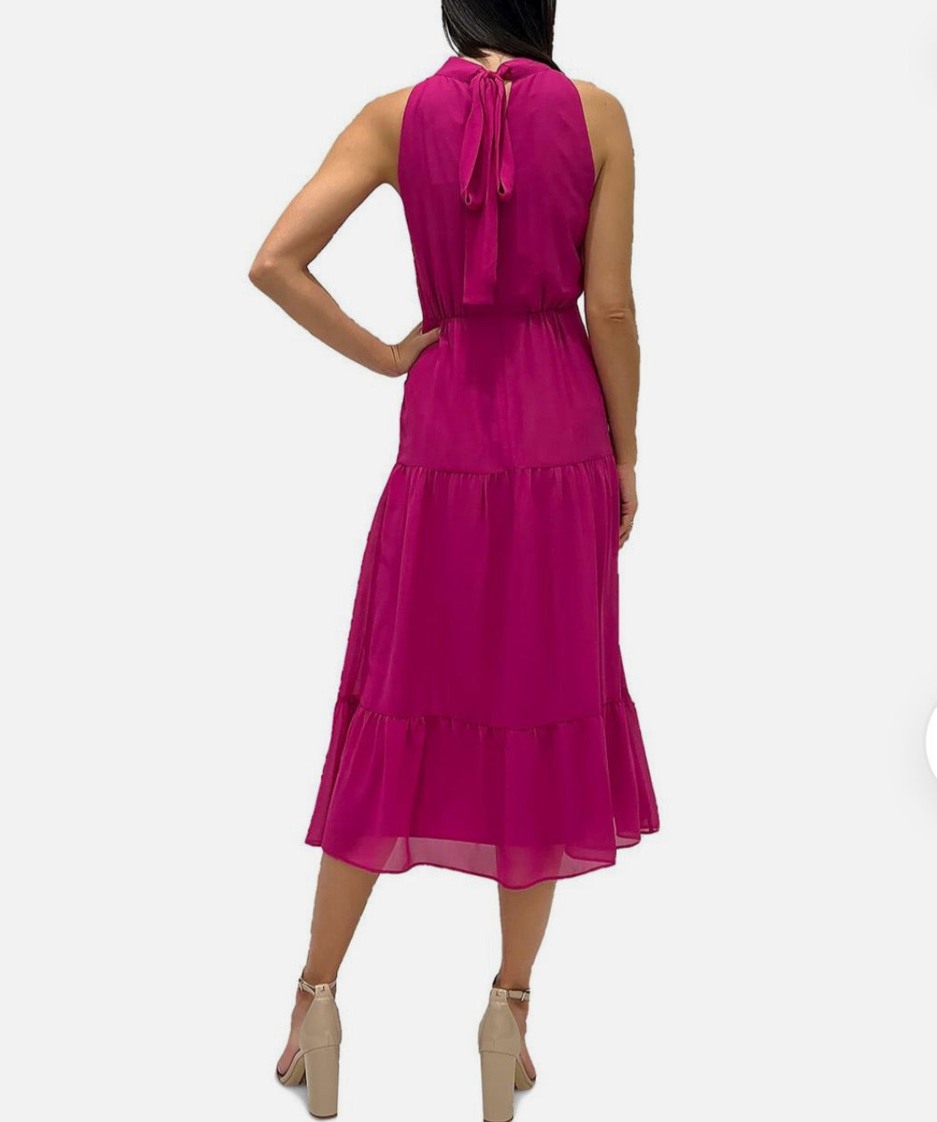 Woman wearing a pink dress with a white background