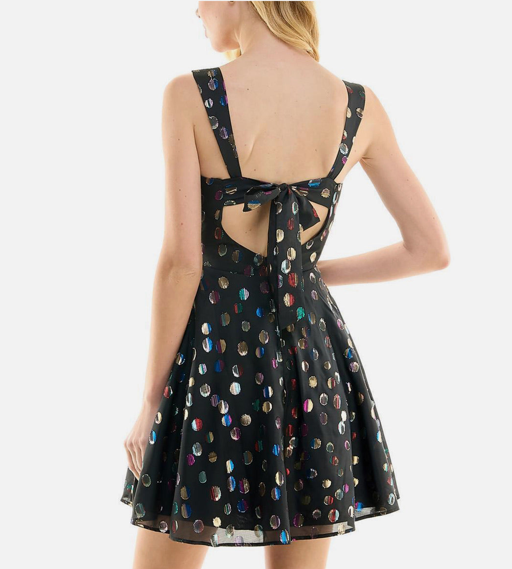 Black dress with colorful polka dots and open back on a white background