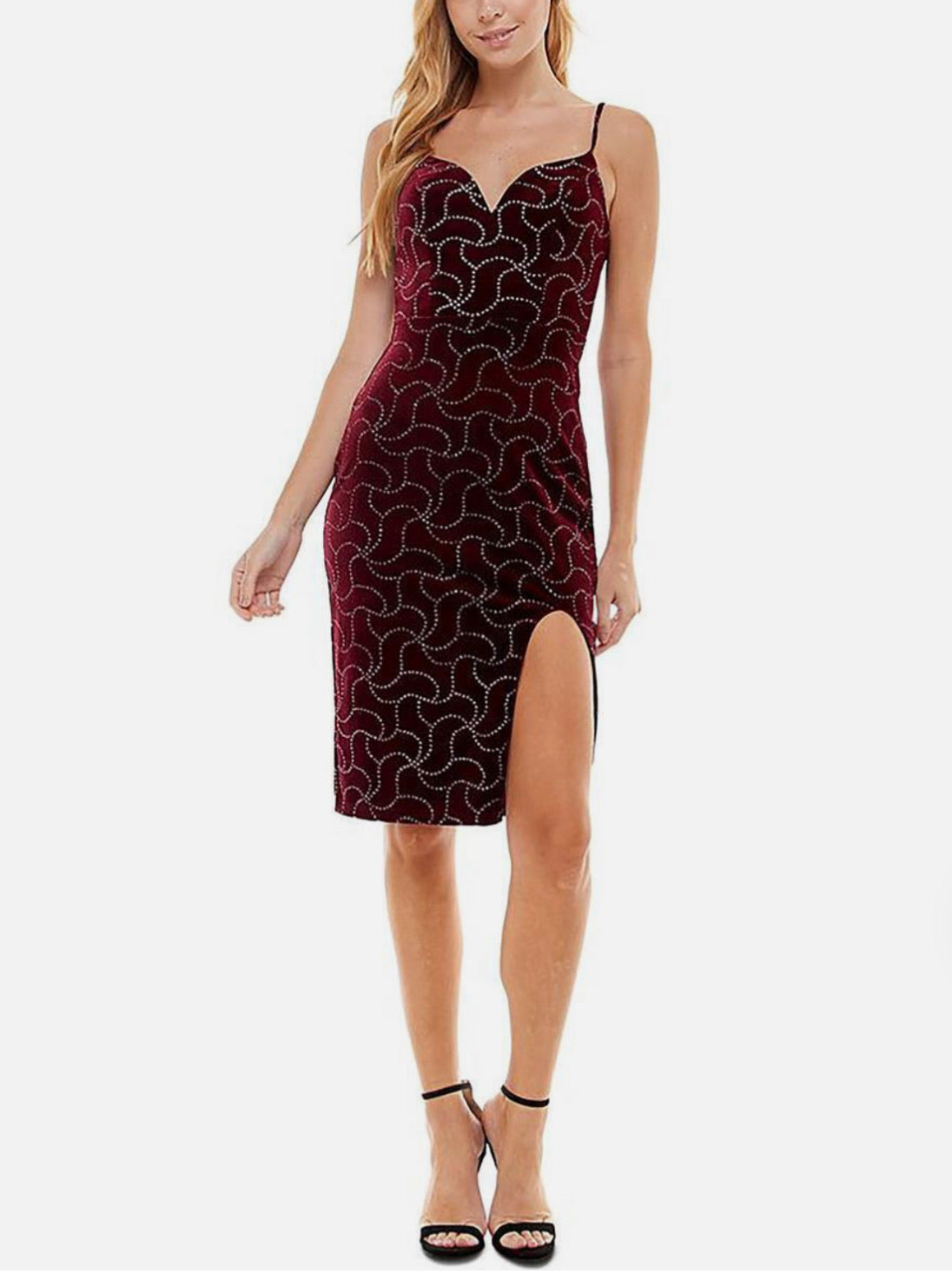 Woman wearing a burgundy patterned dress with a slit on a white background