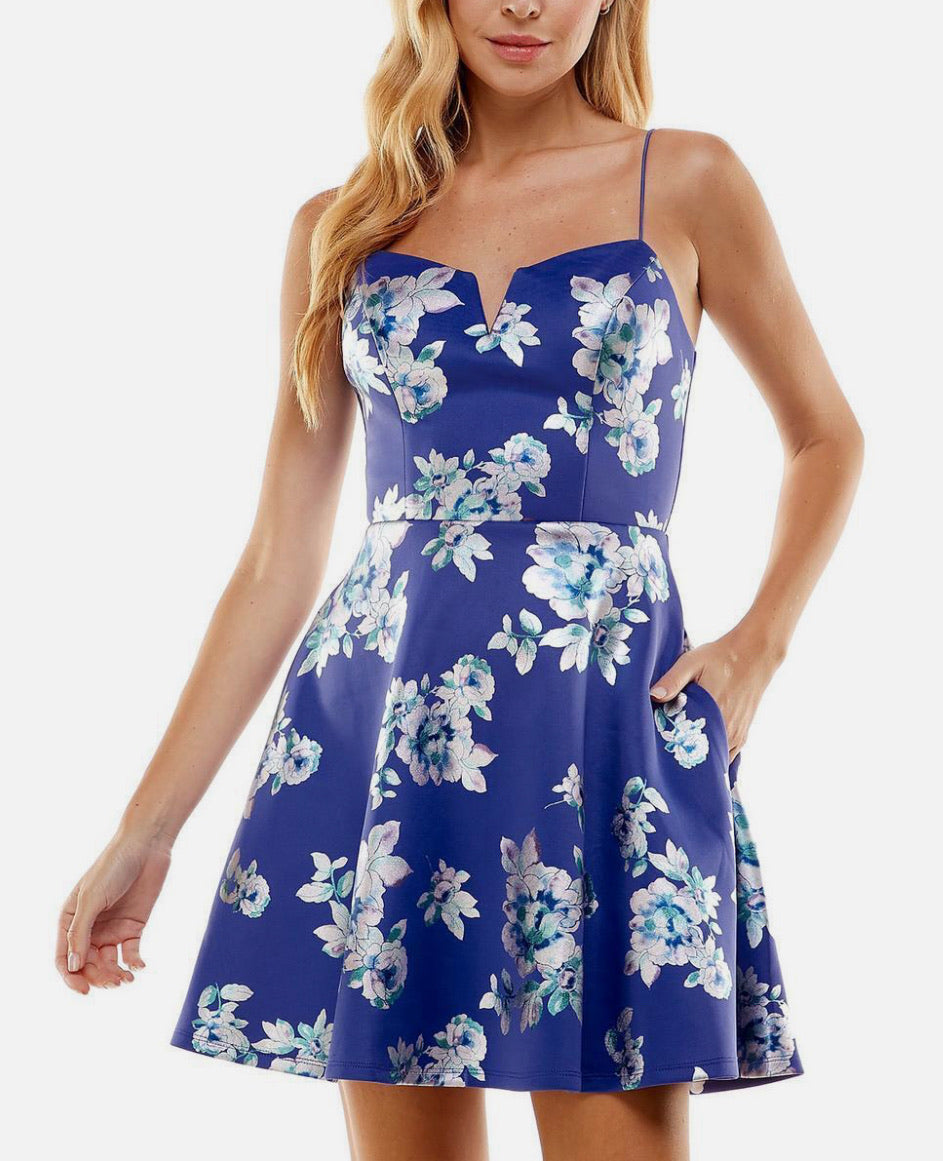 Woman wearing a blue floral dress on a white background