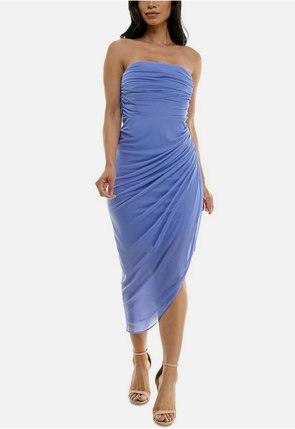 Woman wearing a strapless blue dress on a white background