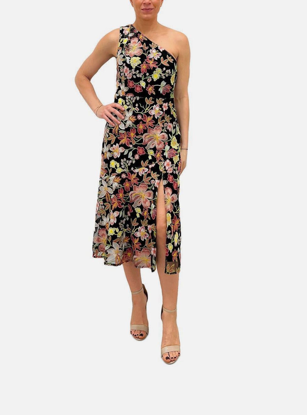 Woman wearing a floral one-shoulder dress on a white background