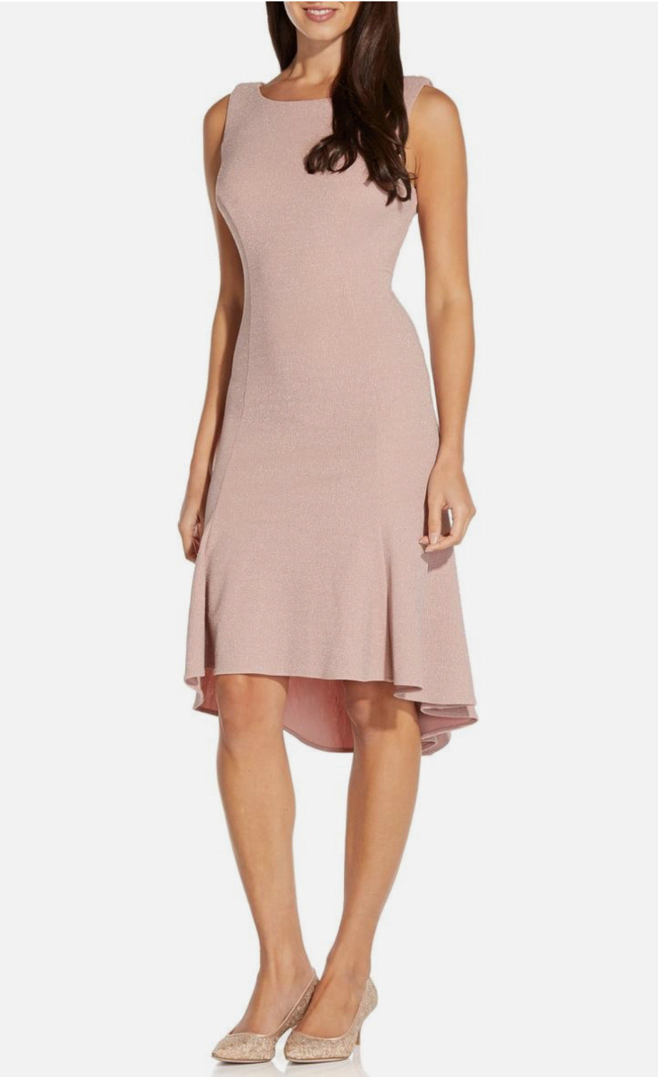 Woman wearing a sleeveless pink dress on a white background