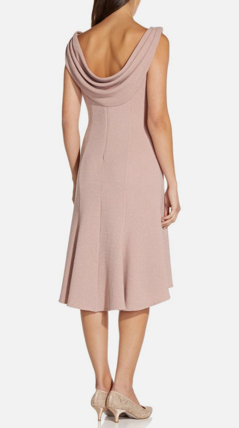 Woman wearing a pink dress with a plain background