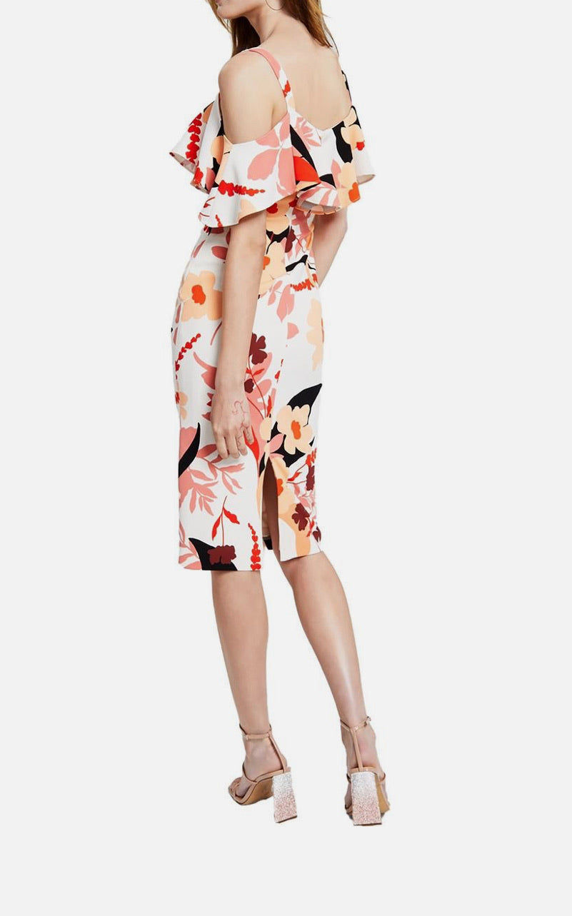 Woman wearing a colorful floral dress on a white background